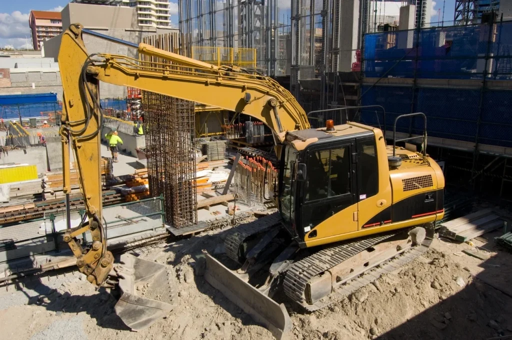 A forklift on a construction site doing excavation and digging work.