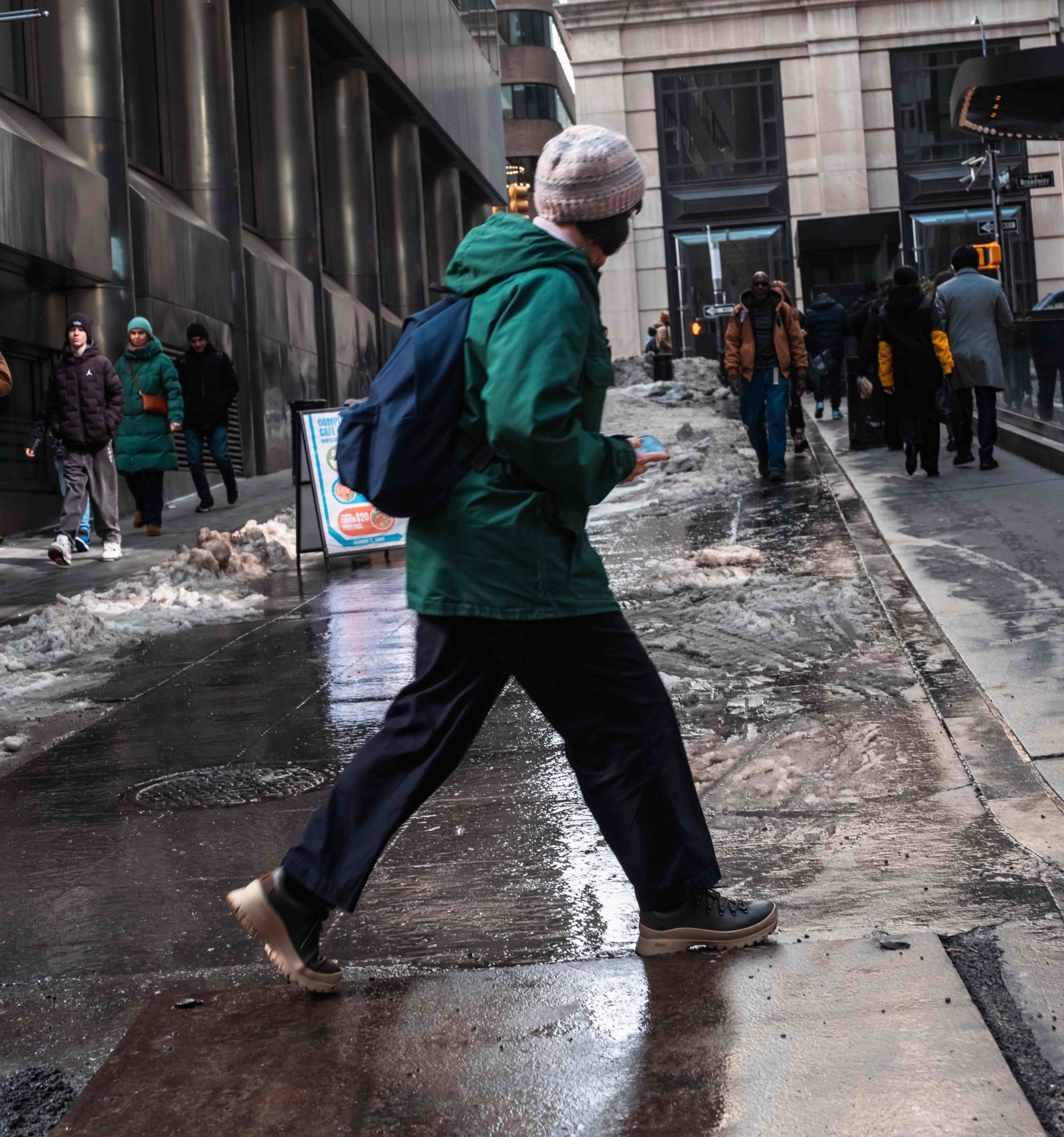 a pedestrian walking on a slippery sidewalk